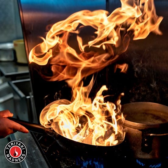 Wok cooking food with fire